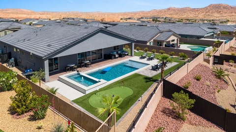Amazing outdoor living - pool, 10 person hot tub, putting green, side yard for games and patio furniture.