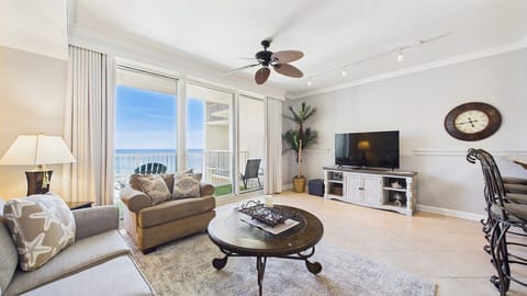 Open concept living area with stylish furnishings TV and balcony access