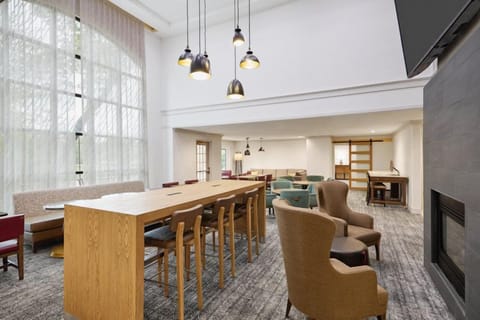Gather around the expansive communal table, perfect for casual meetings or enjoying morning coffee.