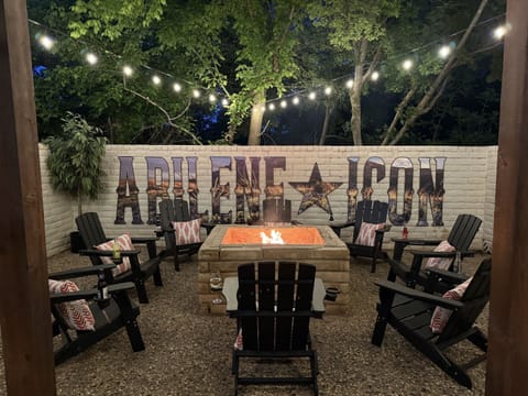Gather 'round the campfire where the Abilene Icon mural stands tall against the rustic brick wall. As twilight falls and the string lights twinkle like stars in the Texas sky, swap tall tales or toast a marshmallow while the embers glow.