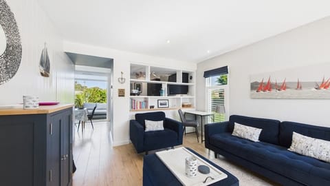The social heart of this holiday home includes a Smart TV and comfortable seating for four.