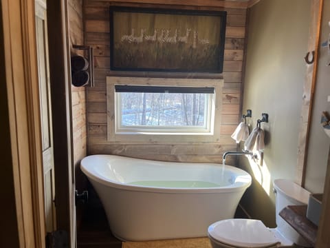 Treehouse in the Bay. Sleeps 10. If available, our smaller Treehouse with a hot tub could be added. This is our Treehouse in the Bay which has lake access and views, an outdoor shower, 8 person sauna, cold tub, and Blackstone grill