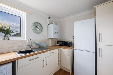 A fully equipped kitchen with all the essentials you need to prepare and enjoy a home-cooked meal.