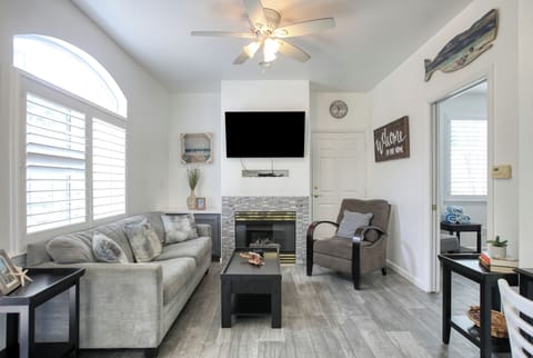 This cozy downstairs unit features a bright living space with modern coastal decor, a fireplace, and plenty of natural light.
