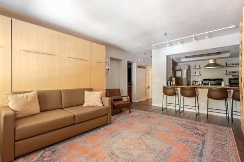 Beds fold up into sleek wall panels, instantly creating space for a cozy couch and an open, carpeted area—perfect for playing games on the floor or yoga. A smart, stylish way to maximize comfort and flexibility.