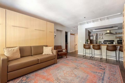 Beds fold up into sleek wall panels, instantly creating space for a cozy couch and an open, carpeted area—perfect for playing games on the floor or yoga. A smart, stylish way to maximize comfort and flexibility.