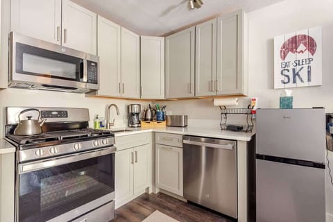 Fully equipped kitchen with stove, microwave, fridge, dishwasher, and storage—ideal for cooking during extended stays.