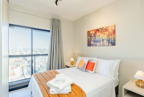 Quarto com cama de casal grande e linda vista da cidade.