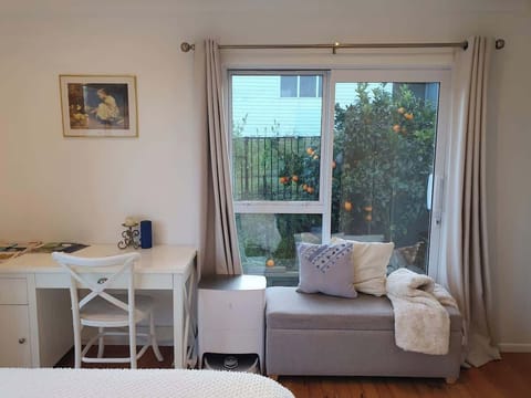 Work desk and bench seat beneath window with garden view