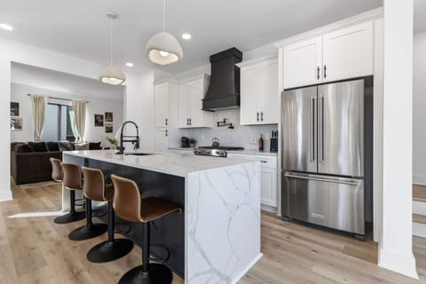 Discover this chic, modern kitchen, perfect for your Nashville getaway! With luxurious finishes and ample space, it's ideal for family reunions or corporate retreats. Enjoy upscale comfort and gather around the stylish island!