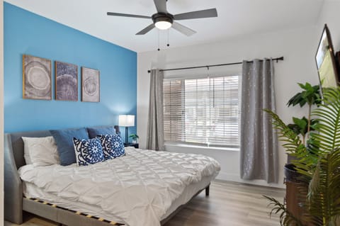 Serene bedroom with a pop of blue and comfy, inviting style.