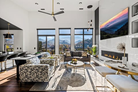 The living room is the heart of the cabin, featuring cozy seating, a warm fireplace, and large windows that frame the Smoky Mountain views. Whether gathering for games, movies, or quiet moments, it’s the perfect place to relax and connect.