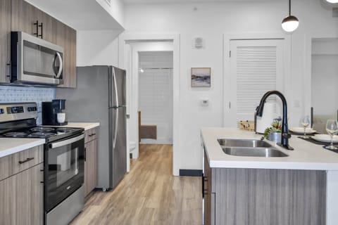 Kitchen area with all stainless steel appliances - microwave, Keurig pod coffee maker, dishwasher, range & refrigerator!