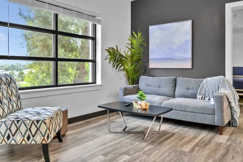 Living room with comfortable couch & accent chair seating & 50" Smart TV!