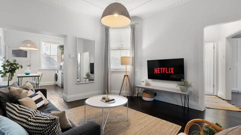 Relax in style with this cosy living space, featuring a sleek modern design and all the comforts of home, including Netflix on the big screen.