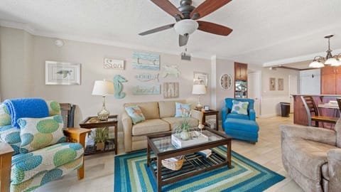 Bright living area with beachy décor, vibrant seating, and an open layout for easy gathering.