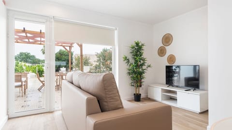 The open living room leads to a pergola-covered patio, perfect for morning coffee or evening wine. #SunlitSpaces #TerraceLiving