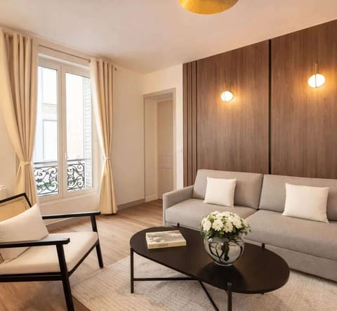 The living room features a sofa, HD flat-screen TV, and free high-speed Wi-Fi.