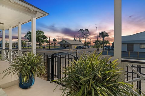 Property featuring a covered terrace with tropical plants and colorful sunset views over the surrounding area.
