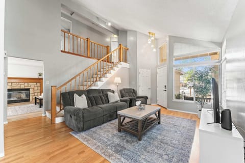 Bright living room with fireplace, TV, and comfortable seating.