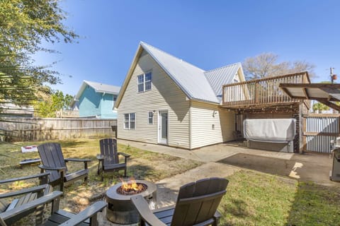 Step into a spacious backyard with lush greenery, a cozy seating area, and a fire pit—perfect for relaxing or entertaining.