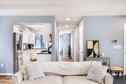 The kitchen’s right behind the sofa—grab a snack mid-movie night or chat with friends while you prep. Even the corner shelf has a few cozy touches.