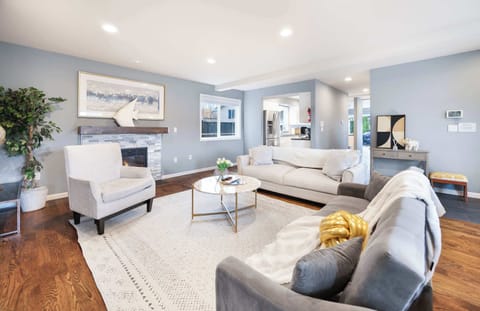 Our cozy living room offers a perfect blend of modern comfort and artistic charm. The comfy sofa, accented with soft throw pillows, invites you to relax.