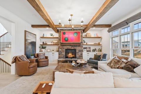 Stone fireplace, smart TV and cozy seating in this gorgeous living space.