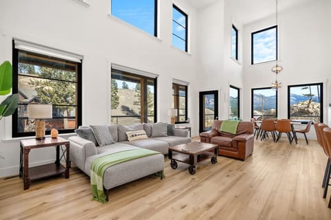 Living room with a 65` Smart TV, sound system, electric fireplace, board games and cozy seating options.