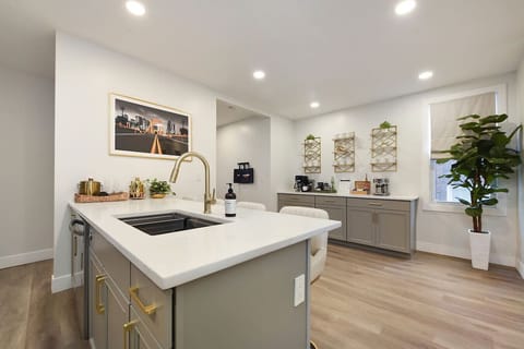 Stylish kitchen island with sleek countertops, perfect for meal prep or enjoying coffee at the bar.
