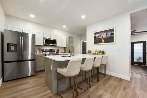 Sleek kitchen with a stylish island and seating, perfect for family meals or a morning coffee.