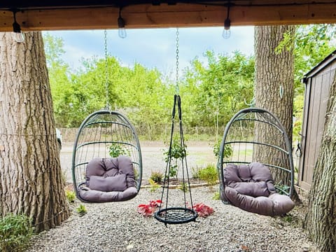 Fun outdoor seating with birdcage swings and a convenient on-site parking space.