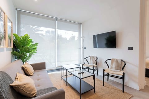 Bright and modern living area with large windows, perfect for relaxation and enjoying the view. A stylish retreat for your vacation!