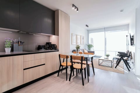 Experience modern living in this stylish studio with a sleek kitchen and cozy dining area, bathed in natural light.