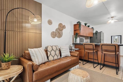 Warm, stylish living space with rattan accents and open kitchen