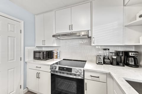 Kitchen with counter top appliances, coffee Keurig, blender and toaster.