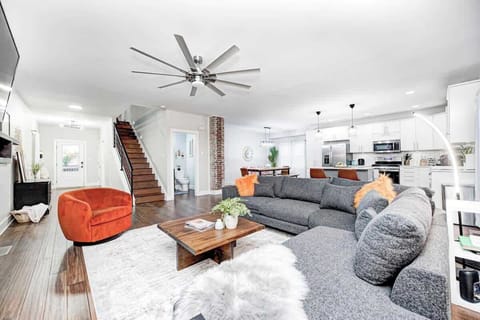 Comfort meets function in this open-layout living room. Enjoy direct access to the fully stocked kitchen and dining area—perfect for easy conversation and shared moments.