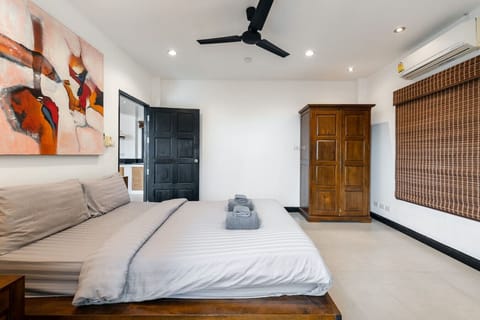 Modern tropical living area with wood-beam ceiling and open-plan design at Sunview Paradise Village
