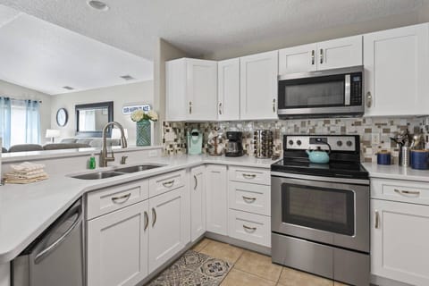 Open-concept kitchen equipped with modern appliances and countertop seating, perfect for cooking and gathering with family and friends.