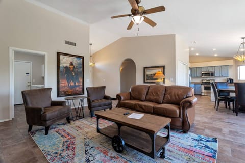 Living room with leather sofa, 2 chairs and 55" Smart TV with Streaming Services ONLY