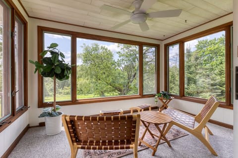 Step out onto the sun-drenched porch, a perfect spot to unwind with a book or simply enjoy the tranquility. 