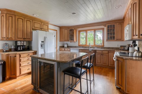 The spacious kitchen island is complete with a wine fridge, inviting relaxation and entertainment into your stay.