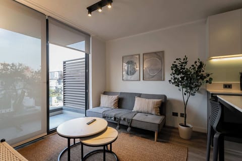Relax in this stylish living area with balcony access, perfect for unwinding after exploring the city.