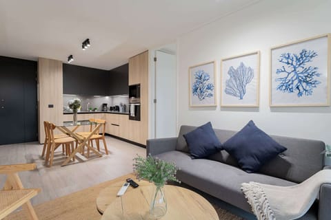 Experience modern comfort in this stylish living area, featuring a sleek kitchen and cozy seating—perfect for relaxing after a day of adventure!