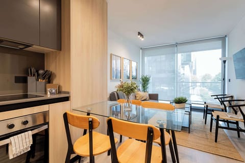 Bright and modern living space with a stylish kitchen and cozy seating, perfect for relaxing after a day of adventure.