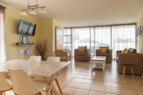 Open plan living/dining room from kitchen. Sliding doors on to private patio.