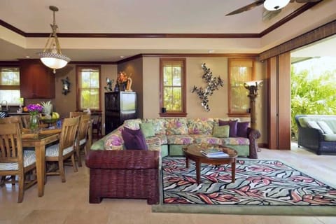 Colorful living room with floral sectional, woven textures, and bright views of the outdoor space.