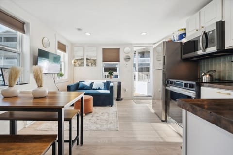 Convenient kitchen setup right across from a dining table that seats 4 —perfect for shared meals!