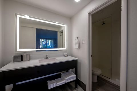 Refresh at the bright vanity with glowing, spa-style mirror.