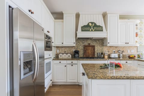 Fully stocked kitchen opens to breakfast area and lounge.

